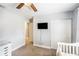 Neutral bedroom featuring a ceiling fan, tv, and a spacious closet at 6490 22Nd S St, St Petersburg, FL 33712