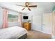 Bright bedroom with ceiling fan, large closet, and dresser with natural light at 6490 22Nd S St, St Petersburg, FL 33712