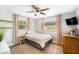 Cozy bedroom with ceiling fan, and dresser featuring two windows providing natural light at 6490 22Nd S St, St Petersburg, FL 33712