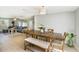 Open-concept dining area connecting to the living room, with a wooden table and ample seating at 6490 22Nd S St, St Petersburg, FL 33712