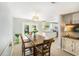 Bright dining area with wooden table, pendant lighting, and backyard view at 6490 22Nd S St, St Petersburg, FL 33712