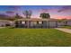 Charming single-story home with a well-maintained lawn and inviting curb appeal at sunset at 6490 22Nd S St, St Petersburg, FL 33712