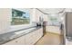 Bright kitchen featuring white cabinets, granite countertops, and stainless steel appliances at 6490 22Nd S St, St Petersburg, FL 33712