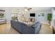 Cozy living room with modern furniture, a large gray sofa, and bright natural light at 6490 22Nd S St, St Petersburg, FL 33712