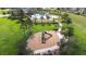 Aerial view of the community park and pool, with playground slide and picnic benches at 6563 Ryestone Way, Wesley Chapel, FL 33545