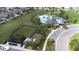 Wide aerial view of community amenities, including a dog park, pool, clubhouse, and ample parking at 6563 Ryestone Way, Wesley Chapel, FL 33545