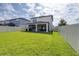 Expansive backyard showcasing lush green grass, white privacy fence and a covered patio at 6563 Ryestone Way, Wesley Chapel, FL 33545
