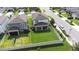 Aerial view of a spacious backyard with green grass, a white fence and a playset at 6563 Ryestone Way, Wesley Chapel, FL 33545