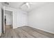 A secondary bedroom displays wood-look floors, a ceiling fan, and a built-in closet at 6563 Ryestone Way, Wesley Chapel, FL 33545