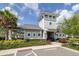 Beautiful community clubhouse featuring neutral colors, a charming round window, and lush landscaping at 6563 Ryestone Way, Wesley Chapel, FL 33545