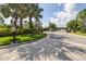 Gated community entrance with landscaping and brick-paved road at 6563 Ryestone Way, Wesley Chapel, FL 33545