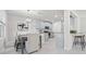 Bright dining area with modern light fixture, gray table and chairs, and view of the kitchen at 6563 Ryestone Way, Wesley Chapel, FL 33545