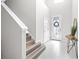 Bright foyer with tile flooring, a decorative mirror, and a staircase leading to the upper level at 6563 Ryestone Way, Wesley Chapel, FL 33545