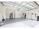 Spacious garage with epoxy flooring, ample lighting, and garage door opener at 6563 Ryestone Way, Wesley Chapel, FL 33545