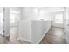 Upstairs hallway displays wood-look floors and white walls leading to multiple bedrooms at 6563 Ryestone Way, Wesley Chapel, FL 33545