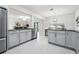 Bright kitchen with stainless steel appliances, granite countertops, gray cabinets, and an open layout at 6563 Ryestone Way, Wesley Chapel, FL 33545