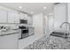 Modern kitchen features stainless steel appliances, light gray cabinets, and granite countertops at 6563 Ryestone Way, Wesley Chapel, FL 33545