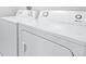 A close-up view shows a brand new, white Amana brand washer and dryer at 6563 Ryestone Way, Wesley Chapel, FL 33545