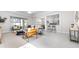 Open-concept living room featuring tile floors, neutral decor, and abundant natural light at 6563 Ryestone Way, Wesley Chapel, FL 33545