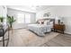 A stylish main bedroom features wood-look floors, a ceiling fan, and updated decorations at 6563 Ryestone Way, Wesley Chapel, FL 33545