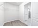 A walk-in closet shows wire shelving and an open entrance to the main bathroom at 6563 Ryestone Way, Wesley Chapel, FL 33545