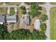 An aerial view shows the home's roofline, adjacent street, driveway, and landscaping at 707 9Th Sw Ave, Ruskin, FL 33570