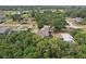 An aerial view presents the backyard surrounded by mature trees, offering privacy at 707 9Th Sw Ave, Ruskin, FL 33570