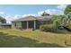 Exterior backyard showcasing screened-in patio and lush greenery, creating a private outdoor oasis at 707 9Th Sw Ave, Ruskin, FL 33570