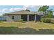 Landscaped backyard with a screened-in patio, providing a serene outdoor living space at 707 9Th Sw Ave, Ruskin, FL 33570