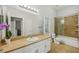 Bathroom features a vanity with a large mirror and a shower and tub combo at 707 9Th Sw Ave, Ruskin, FL 33570