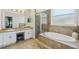 Bathroom featuring double sinks, a walk-in shower, and a luxurious soaking tub at 707 9Th Sw Ave, Ruskin, FL 33570