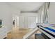 A view of the bedroom with wood flooring and a lofted bed with a slide at 707 9Th Sw Ave, Ruskin, FL 33570