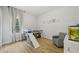Bedroom with wood floors, a lofted bed with a slide, and a grey rocking chair at 707 9Th Sw Ave, Ruskin, FL 33570