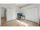 Bedroom featuring a black desk, a gaming chair, and wood flooring at 707 9Th Sw Ave, Ruskin, FL 33570
