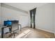 Bedroom with wood flooring, a grey gaming chair, and a window with curtains at 707 9Th Sw Ave, Ruskin, FL 33570