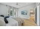 Bedroom offering exterior access, a ceiling fan, and modern amenities at 707 9Th Sw Ave, Ruskin, FL 33570