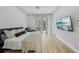 Inviting bedroom with a ceiling fan, backyard access, and a wall-mounted television at 707 9Th Sw Ave, Ruskin, FL 33570