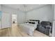 Relaxing bedroom with wood floors, a ceiling fan, and a comfortable armchair at 707 9Th Sw Ave, Ruskin, FL 33570