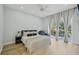 Comfortable bedroom featuring light wood floors, recessed lighting, and access to the backyard at 707 9Th Sw Ave, Ruskin, FL 33570