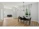 Bright dining area with views to the living area and modern chandelier and white curtains at 707 9Th Sw Ave, Ruskin, FL 33570
