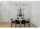Elegant dining room with modern chandelier and a view to the front yard and white curtains at 707 9Th Sw Ave, Ruskin, FL 33570