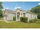 Inviting home with a manicured lawn, covered entry, and a detached two-car garage at 707 9Th Sw Ave, Ruskin, FL 33570