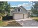 Charming home featuring a three-car garage, neutral paint, and well-manicured lawn at 707 9Th Sw Ave, Ruskin, FL 33570