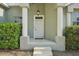 Inviting front entrance with decorative columns, a classic white door, and manicured landscaping at 707 9Th Sw Ave, Ruskin, FL 33570