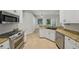 Open kitchen featuring stainless steel appliances, granite countertops, tile floors, and ample natural light at 707 9Th Sw Ave, Ruskin, FL 33570