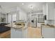 Bright kitchen features stainless steel appliances, granite countertops, and white cabinetry at 707 9Th Sw Ave, Ruskin, FL 33570