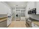Modern kitchen boasts stainless steel appliances, light countertops, and white cabinets at 707 9Th Sw Ave, Ruskin, FL 33570