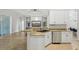 Bright kitchen with granite countertops and stainless-steel appliances, overlooking the living area at 707 9Th Sw Ave, Ruskin, FL 33570