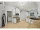 Bright kitchen includes stainless steel appliances, granite countertops, white cabinets, and tile flooring at 707 9Th Sw Ave, Ruskin, FL 33570