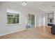 Sunlit living area featuring large windows, tile flooring, and sliding glass door to the outdoor patio at 707 9Th Sw Ave, Ruskin, FL 33570